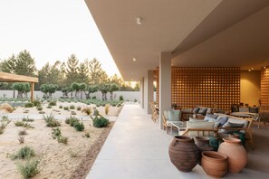 A modern outdoor lounge area with seating and planters. - Spatia Comporta, a Member of Design Hotels (Grandola)