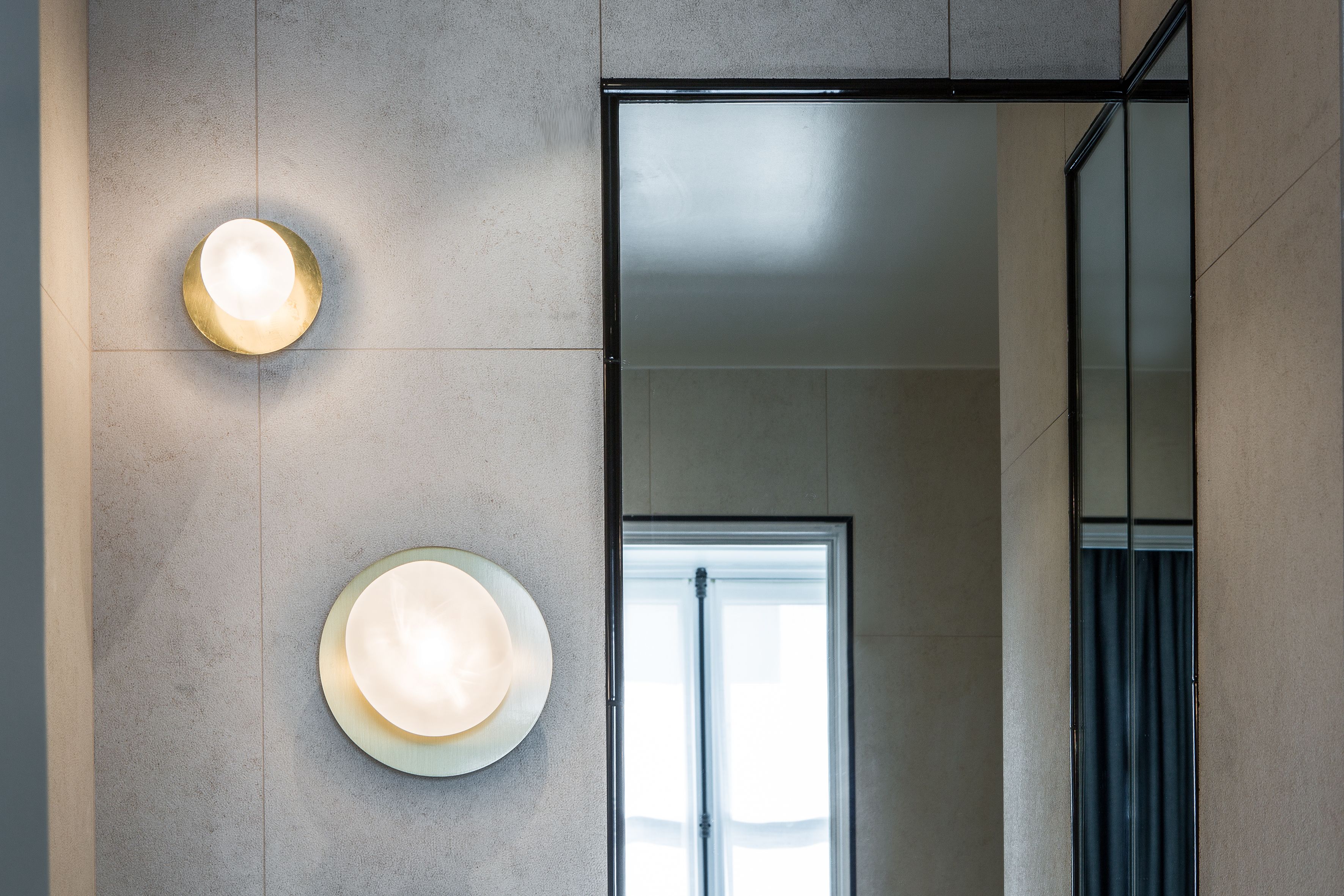 A modern interior with a light fixture and a glass door.