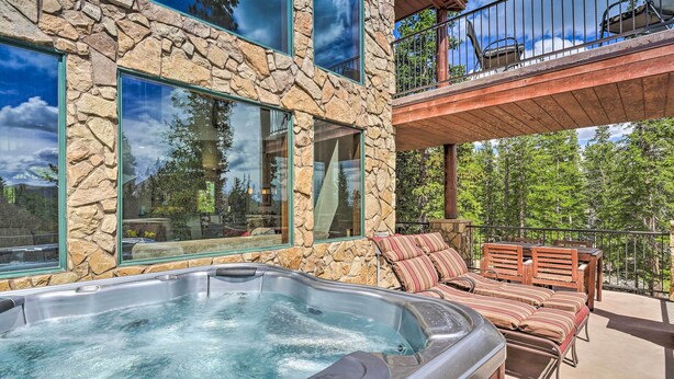 A stone building with a hot tub and outdoor seating. - 26-0111 Fairplay Home w/ Hot Tub & Mountain Views! (Fairplay)