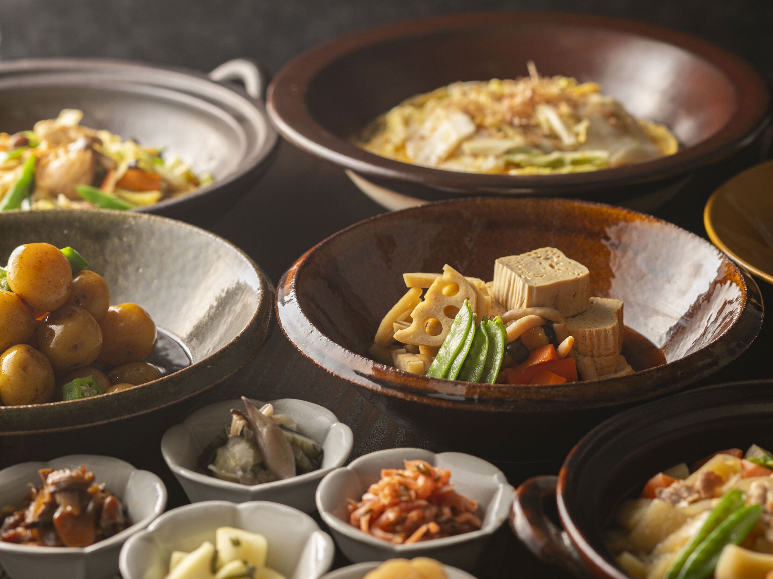 A variety of dishes in different bowls, suggesting a meal setting.