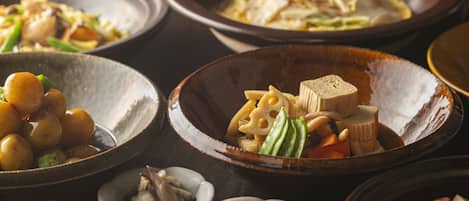 A variety of dishes in different bowls, suggesting a meal setting.