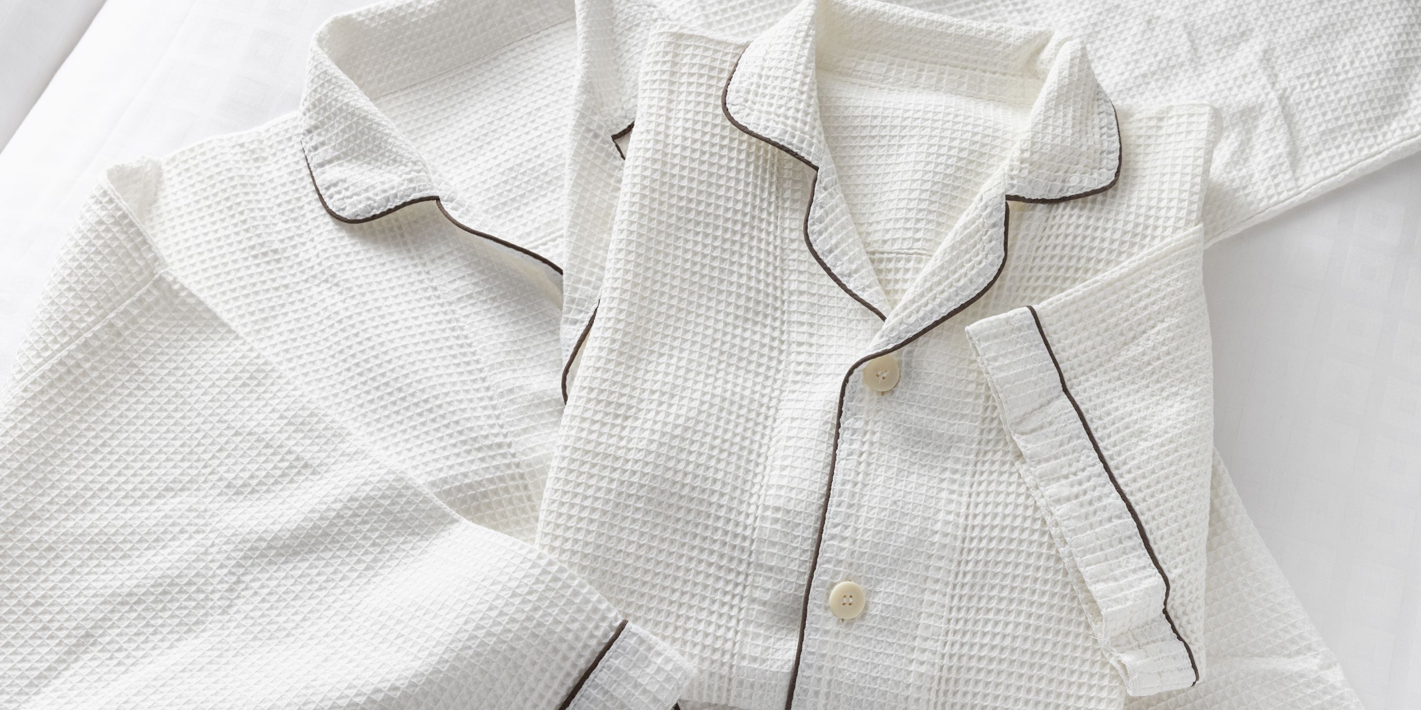 A white shirt with a textured pattern and buttoned cuffs.