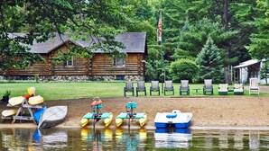 A log cabin with a dock and kayaks. - Premium Amenities Included! Cabin 9 - POV Resort (Phelps)