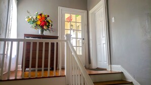 A staircase with white railings leading to a door with a window. - Spacious (2/1, 1100 sqf) - 5 -15 minutes to Airport, Downtown, SeaWorld, etc. (San Antonio)
