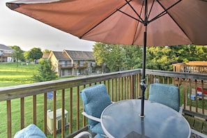 Enjoy outdoor dining or relaxation on this deck with a glass-top table and comfortable seating.