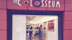 The Coloseum entrance with a glass facade, a sign above the entrance, and people inside. - Uber Luxurious NYC-Style Penthouse, Two Minutes Walk from Long Street (Cape Town)