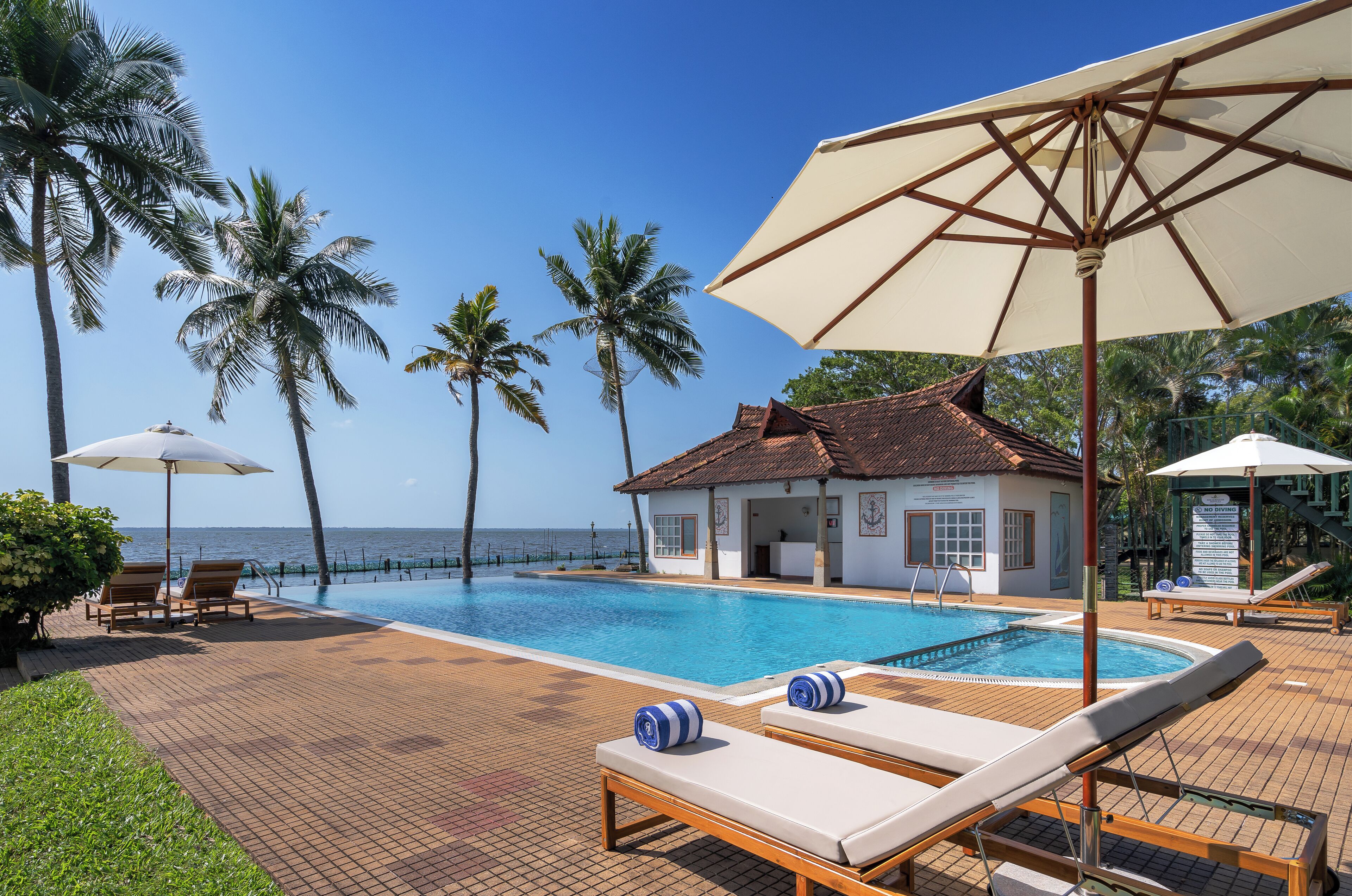 Alberca al aire libre, sombrillas en la alberca y camastros 