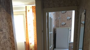 A room with a bed, a desk, and a chair. There is a window with curtains, and a door leading to another room. - Nostalgy House Moldova (Râşcani)