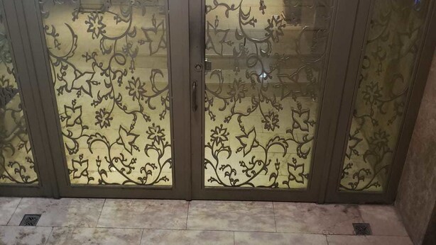 A set of double doors with intricate floral patterns, leading to a tiled floor area. - Arkin Daire 1 bedroom (Alanya)