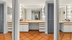 A bathroom with a double vanity, two sinks, and a mirror above each sink.