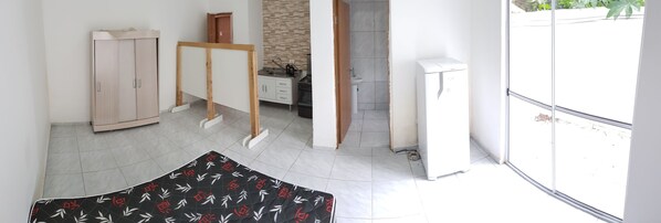 Relax in a stylish room with a comfortable bed, kitchenette, and ample natural light.