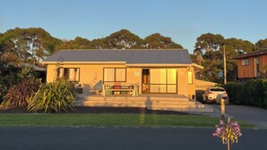 A modern two-story house with a garage, a driveway, and a well-maintained lawn.