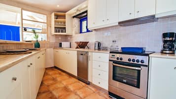 Villa | Private kitchen | Fridge, microwave, oven, stovetop