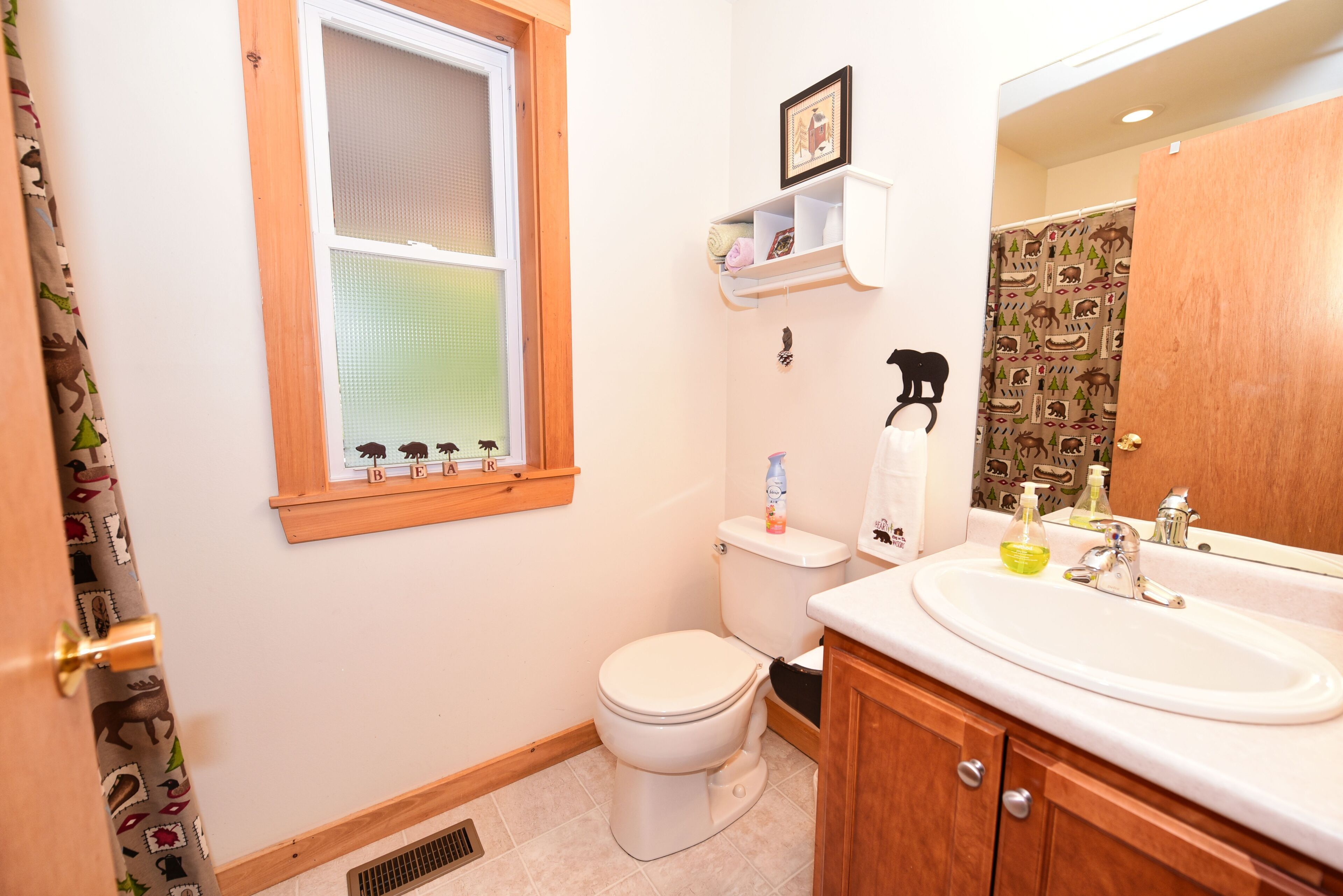 A bathroom with a toilet, sink, and shower.