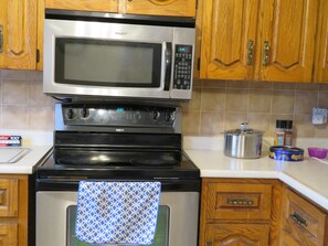 Microwave, dishwasher, coffee/tea maker, cookware/dishes/utensils