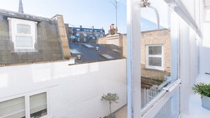 A residential building with a white exterior, a visible chimney, and a small tree in the window sill. - Bright Studio Flat in Central London Zone 1 Paddington / Lancaster gate cozy (London)