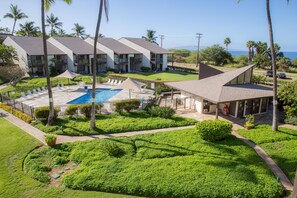 A resort with multiple buildings, a swimming pool, and lush greenery. - Hale Kamaole 308 Third floor condo, easy access to best beach on Maui! (Kihei)