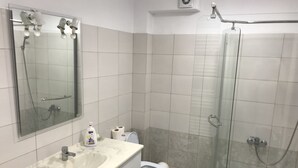 A bathroom with a sink, toilet, and glass-enclosed shower. - Beautiful SeaSide Apartments (Mamaia-Sat)