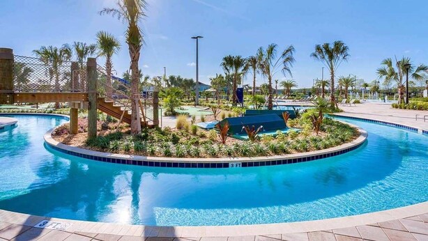 A swimming pool with a 3 FT depth marker, surrounded by palm trees and a wooden deck. - Awesome Daydreamer Home, Pool, Waterpark, Slides, Lazy River, near all Parks (Kissimmee)