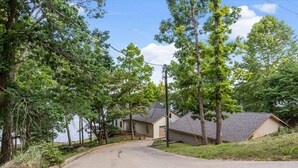 A residential street with houses, trees, and a clear sky. - Group Getaway w/ Dock! Lakefront Escape in Stover (Stover)