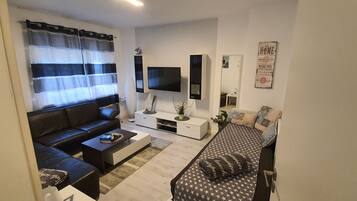 Apartment (Wohnung 1) | Living area | 100-cm flat-screen TV with cable channels, TV, Netflix