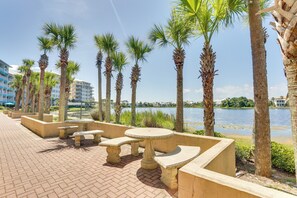 Stroll along the paved walkway lined with palm trees and enjoy a serene atmosphere by the water.