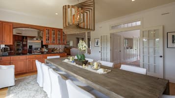 Enjoy meals at the kitchen island with bar stools, surrounded by ample cabinetry and modern appliances.