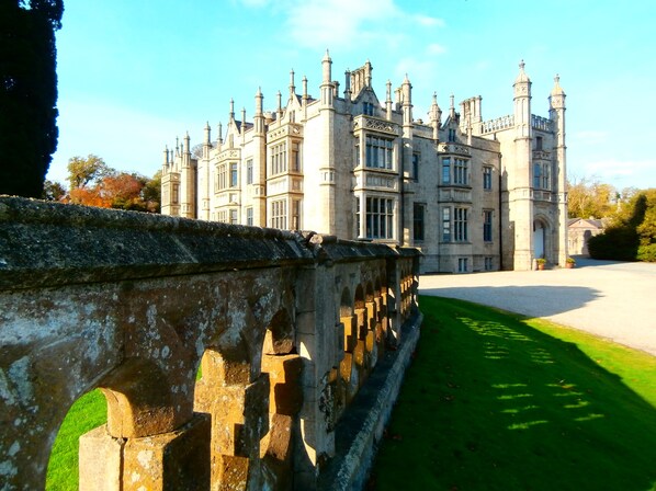 A large, historic building with multiple towers and a well-maintained lawn in front. - Number 6 Narrow Water Castle (Warrenpoint)