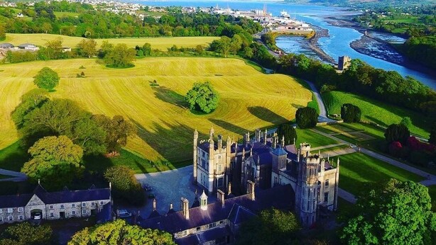 A castle with a large courtyard, surrounded by green fields and a river. - Number 6 Narrow Water Castle (Warrenpoint)