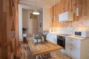 Enjoy cooking in this well-equipped kitchen with a dining table and modern appliances.