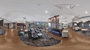 A spacious lobby with a central seating area, a fireplace, and a modern design. - Residence Inn by Marriott Minneapolis Maple Grove/Arbor Lakes (Maple Grove)
