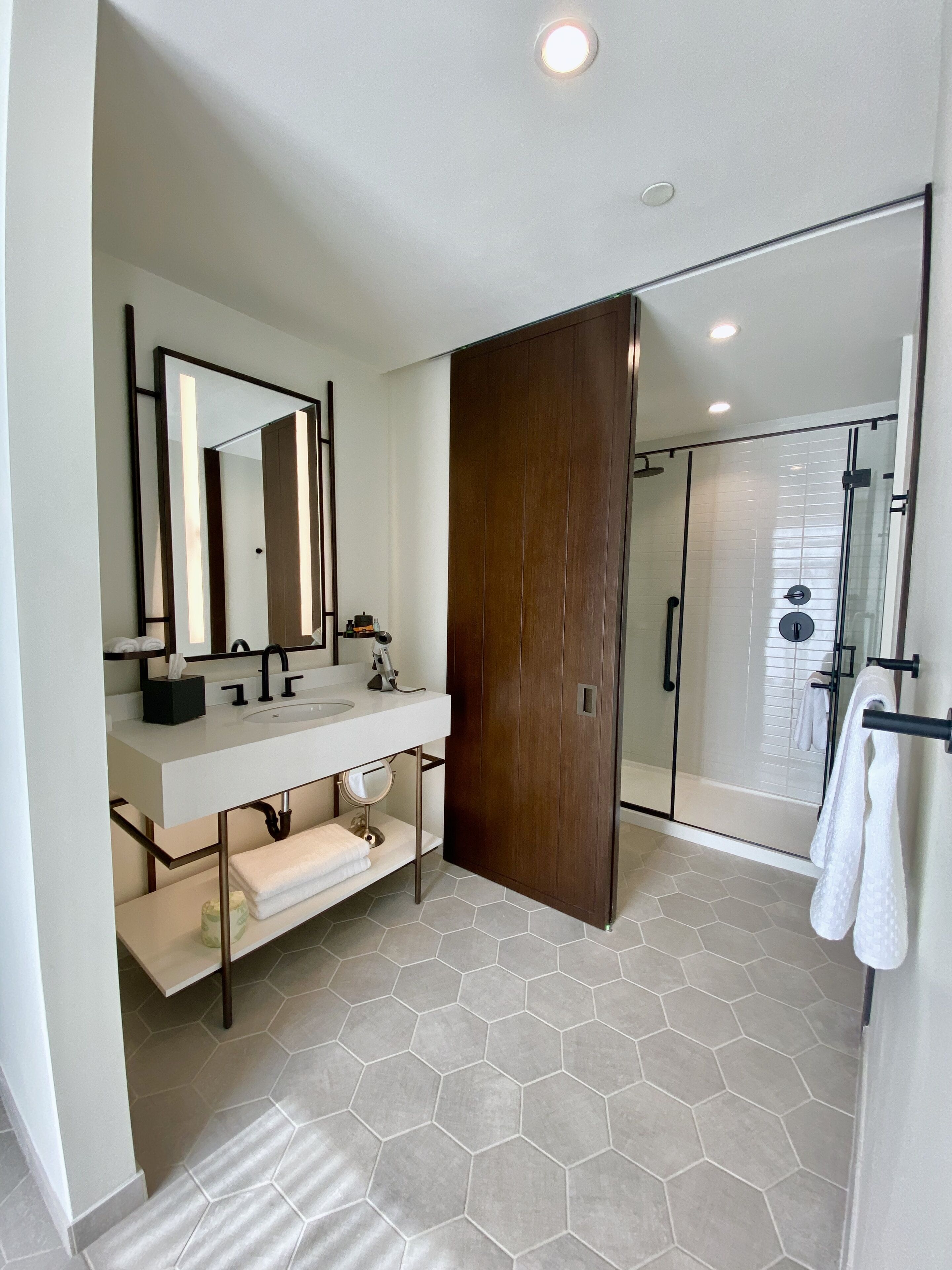 shower, rainfall showerhead, hair dryer, towels