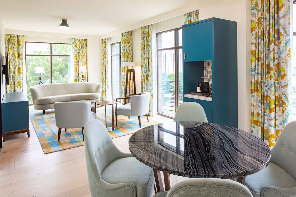 Un salon moderne comprenant un canapé, des fauteuils, une table basse et un meuble.