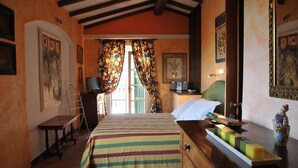 A bedroom with a bed, a dresser, a desk, and a chair. There is a window with curtains, a door, and a wall with a picture. - LAST MINUTE OFFER! Jacuzzi pool, Sauna, A / C, WiFi, close beaches & 5 Terre (ORTONOVO)