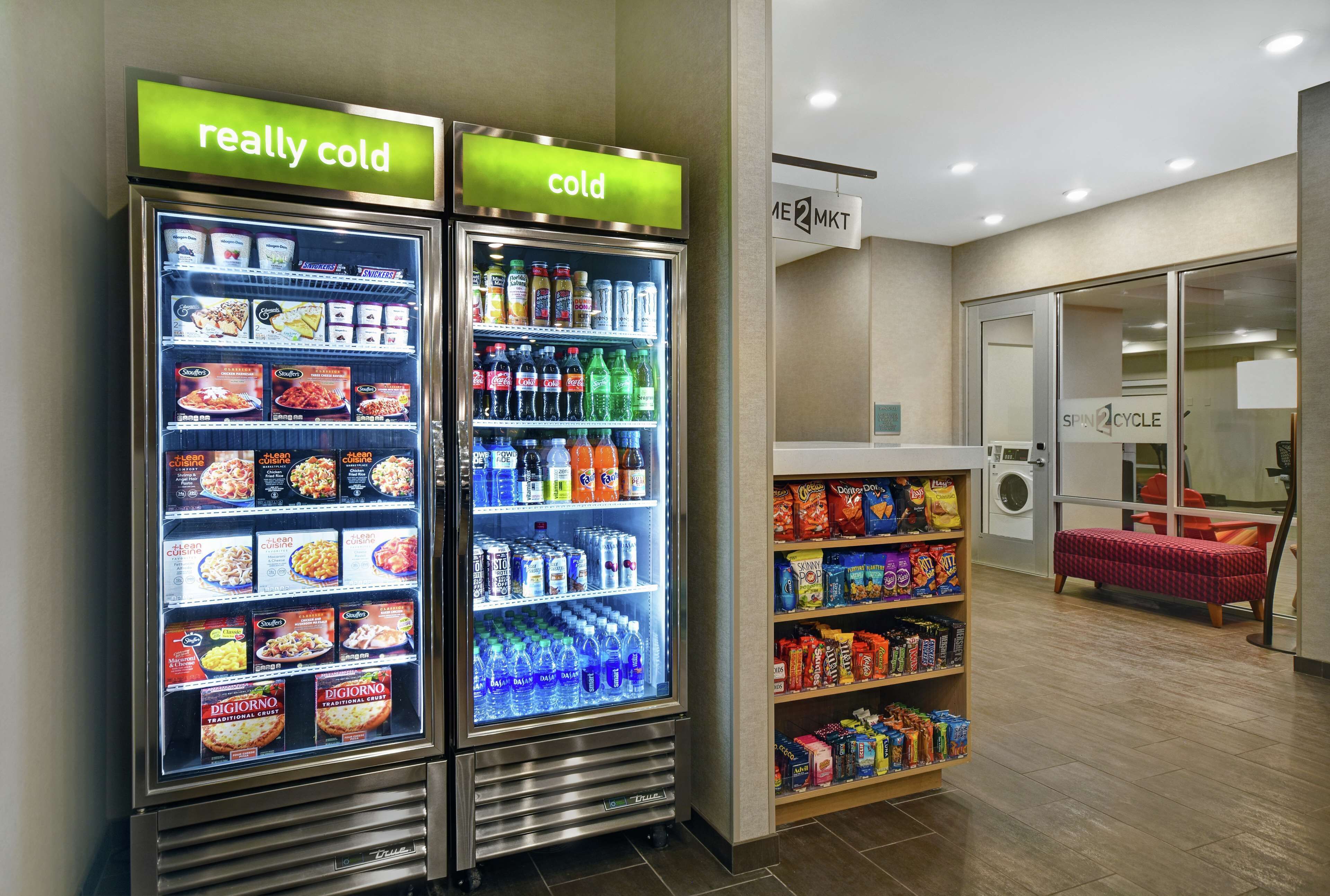 A vending machine area with two refrigerated units labeled "really cold" and "cold," stocked with beverages and snacks.