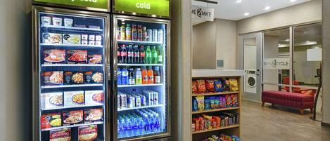 A vending machine area with two refrigerated units labeled "really cold" and "cold," stocked with beverages and snacks.