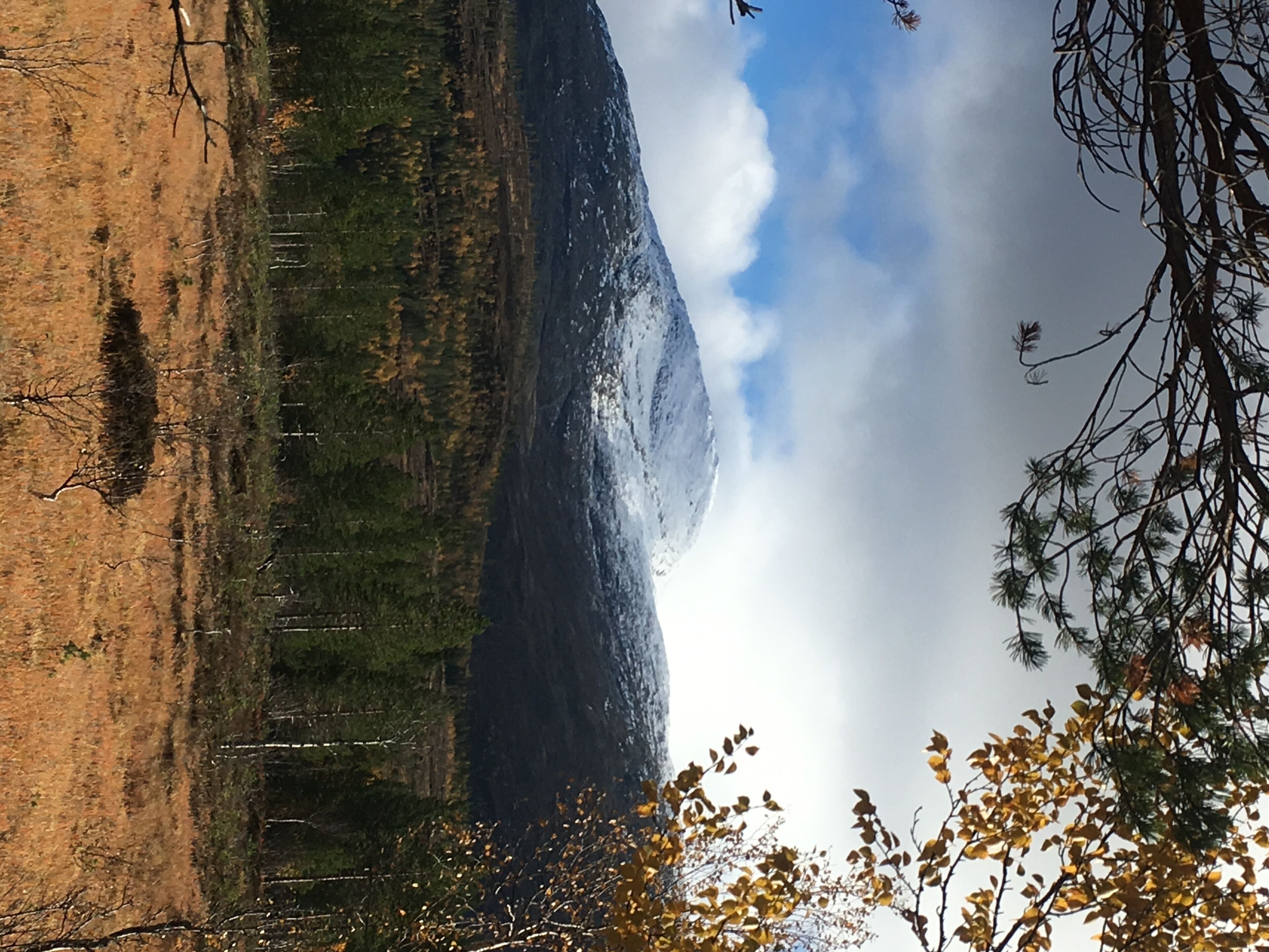 A mountainous landscape with a clear sky and some clouds.