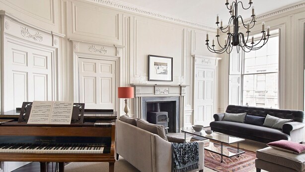 A living room with a grand piano, a sofa, a fireplace, and a chandelier. - A fusion of Georgian and Modern. Impeccably furnished with excellent attention to detail! (Edinburgh)
