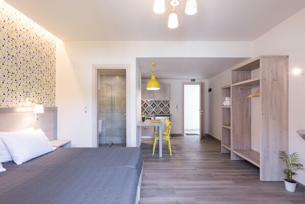A modern hotel room with a bed, a desk, and a wardrobe. - Ipsos Beach Studios By Konnect (Corfu)