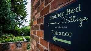 A sign for Feather Bed Cottage indicating the entrance. - Feather Bed Cottage B&B (Coventry)