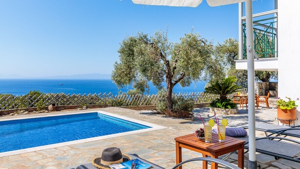 A poolside area with a view of the sea, stone flooring, and outdoor furniture. - Villa Glikeria, W/pool, Lovely Sea Views And Close To Everything (Glossa)