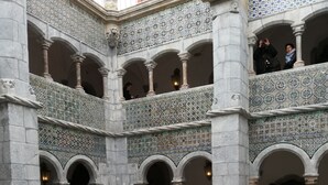 A courtyard with a large, ornate fountain at the center, surrounded by a checkered tile floor and multiple arches. - Casa da Vista Rio  (Amora)