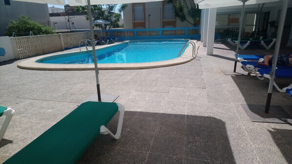 Seasonal outdoor pool, open 8:00 AM to 10:00 PM, pool umbrellas