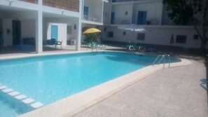 Seasonal outdoor pool, open 8:00 AM to 10:00 PM, pool umbrellas