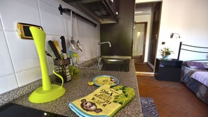 A kitchen with a sink, utensils, and a towel rack. - Machiavelli Apartment (lastra a signa)