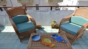 A balcony with wicker furniture, including two chairs and a table. - Agllipoli Penthouse 215 (Gallipoli)