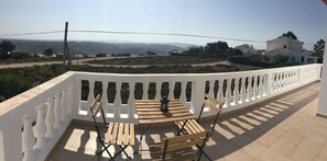 Enjoy breathtaking views of the surrounding hills from this balcony.