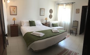 Relax in comfort with a large bed, bedside table, and stylish artwork.