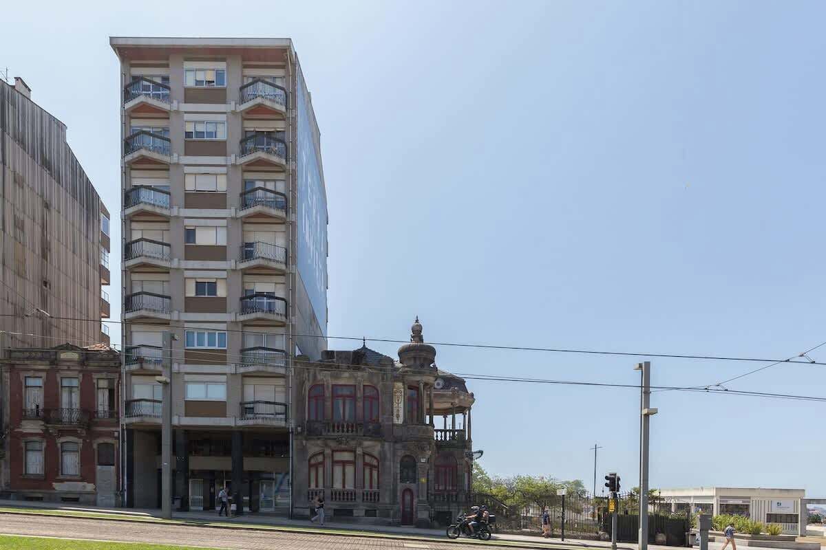 Un edificio de varios pisos con balcones y una fachada histórica.