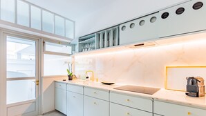 A modern kitchen with white cabinets, a marble countertop, and a built-in oven. - UNIQUE DUPLEX PENTHOUSE & FREE PARKING (Porto)